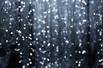 raining white blue light neon bokeh with dark black grey background , Festive defocused lights.