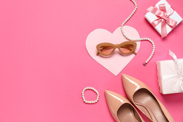 Composition with stylish female accessories, shoes and gift boxes on pink background