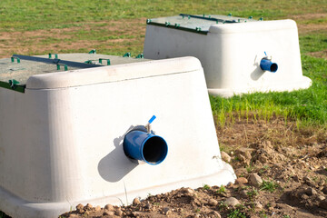 construction workers  install pipes and valves for irrigation in fields with crops and to supply...