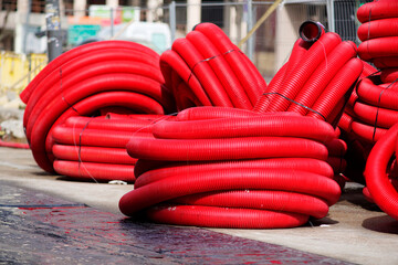 red corrugated pipes for  water or communications or sewer for install  in construction site on street city - 770022501