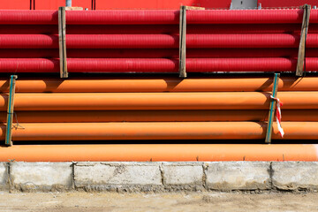 red corrugated pipes for  water or communications or sewer for install  in construction site on street city - 770022523
