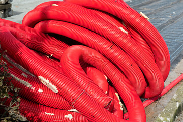 red corrugated pipes for  water or communications or sewer for install  in construction site on street city - 770022536