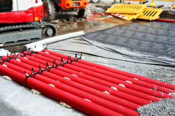 red corrugated pipes for  water or communications or sewer for install  in construction site on street city - 770022549