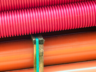 red corrugated pipes for  water or communications or sewer for install  in construction site on street city - 770022559