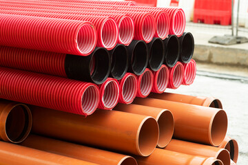 red corrugated pipes for  water or communications or sewer for install  in construction site on street city - 770022563