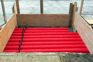 red corrugated pipes for  water or communications or sewer for install  in construction site on street city