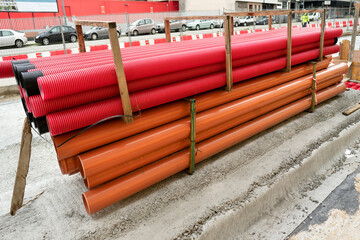 red corrugated pipes for  water or communications or sewer for install  in construction site on street city - 770022599