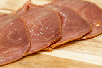 thin slices of Smoked tuna macro food background - 770024395