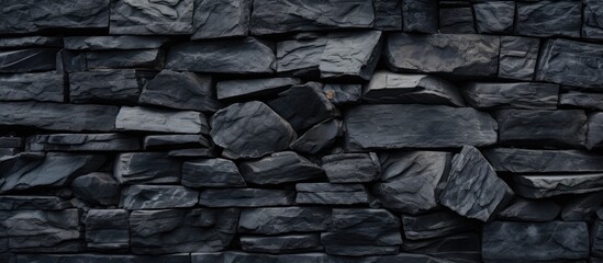 A detailed closeup of a grey bedrock stone wall, showcasing the intricate pattern created by the cobblestone building material