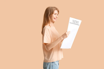 Beautiful young woman with blank newspaper on color background