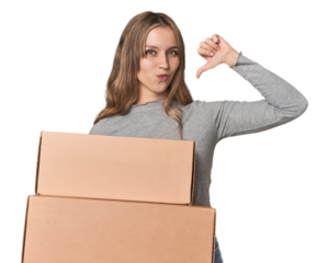 Blonde woman with cardboard boxes moving on studio backdrop feels proud and self confident, example to follow.