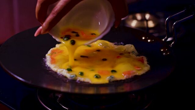 delicious egg omelet made with bacon and tomatoes
in fry pen