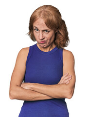 Fototapeta premium Redhead mid-aged Caucasian woman in studio unhappy looking in camera with sarcastic expression.