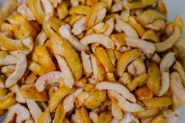 Close-up of dried quince slices, showcasing their textured, golden appearance.