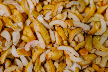 Close-up of dried quince slices, showcasing their textured, golden appearance.