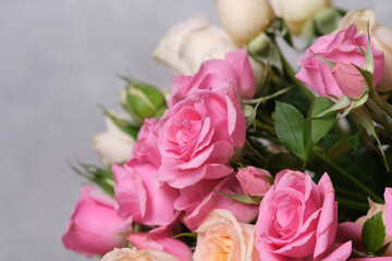 Bouquet of pink roses on a gray background, close-up.