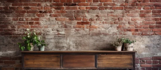 Foto op Plexiglas A hardwood rectangular table displaying various potted plants, placed against a brick wall backdrop. The mix of wood and brickwork creates a charming and natural aesthetic © pngking