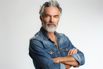 Portrait of a handsome man with gray hair and beard in a casual denim shirt
