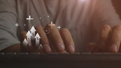 Arrows moving upward with percentages and pluses with dots against the background of the hands of a person working on the keyboard of a PC. Cg footage