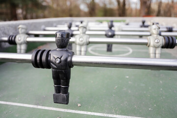 Foosball table. Conceptual image on the theme of one against many. - Powered by Adobe