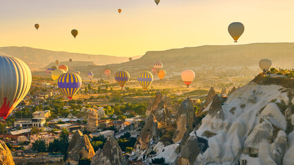 Colorful hot air balloons. Sunrise at Cappadocia. Bright colorful ballons flying during sunrise in valley. Goreme, Nevsehir, Cappadocia - obrazy, fototapety, plakaty