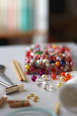 Various craft supplies on white background. Supplies for jewelry making, drawing and needlework. Selective focus.