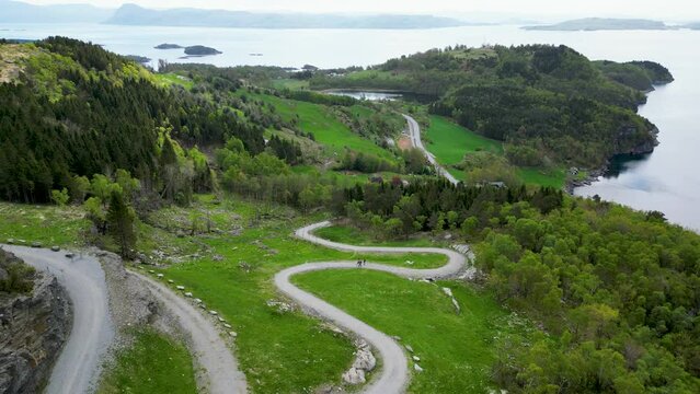 steep gravel path leading up to Himakona (The little Trolltunga) in Nedstrand, Norway, 4K drone.