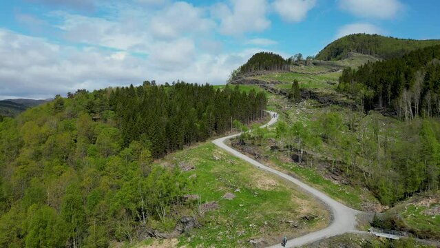 steep gravel path leading up to Himakona (The little Trolltunga) in Nedstrand, Norway, 4K drone.