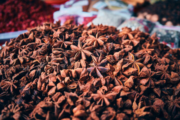 Chinese badian star. Illicium verum. Heap of star anise spices at bazaar stall