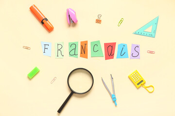 Composition with word FRANCAIS and different stationery on color background