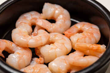shrimps in a pan,Peeled shrimps in a bowl 