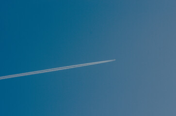 Sky, cloudless weather. An airplane trail in the sky