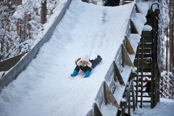 Joyful Descent, A Young Adventurer Embracing the Winter Wonderland
