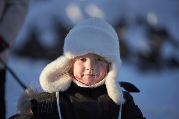 Little Girl in Snow With White Hat
