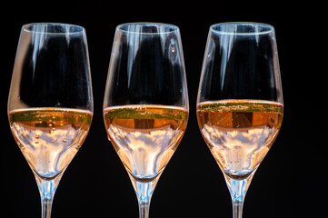 Picnic on green grass with glasses of rose champagne sparkling wine or cava, cremant produced by traditional method in caves in Champagne region, France