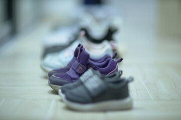 Row of Shoes on Wooden Floor