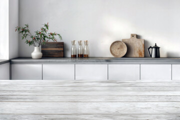 Whitewashed wooden countertop with a modern kitchen shelf and decorative items in the background. Kitchen interior design mockup with space for text. High quality photo
