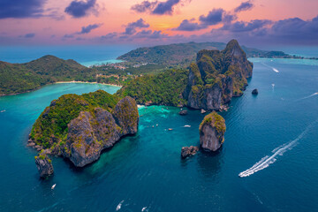 Landscape koh Phi Phi Don island, Krabi, Thailand. Aerial view paradise Nui beach, turquoise lagoon with white coral sand and palms on sunset time.