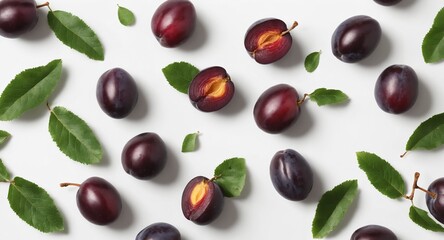 Fresh plums with green leaves on white. Food background. Top view