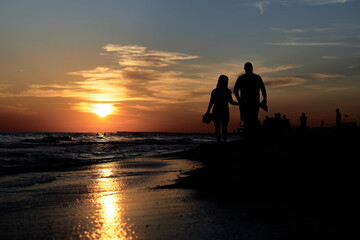 Serene Stroll: A Couple Embracing Love on the Shoreline at Dusk