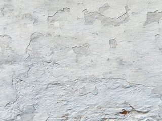 Close-up of a white wall with cracked paint