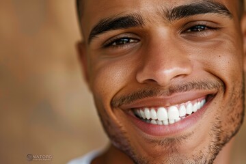 Close up of a handsome young man smiling with perfect white teeth