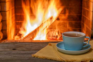 Cozy fireplace,winter vacations, a mug of coffee, fire burning