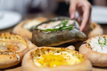 Delicious Khachapuri on a Wooden Serving Board