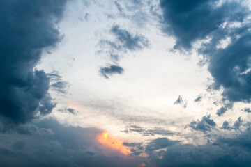 Naklejka na ściany i meble Sunset Sky with Clouds Parting for a Glimpse of Orange Light