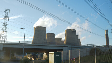 Thermal power plant in Ratcliffe with cooling towers and overhead power line