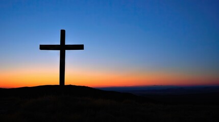 A powerful photograph of a cross silhouetted against a clear blue sky, conveying the significance of the cross in the Christian faith and the promise of redemption