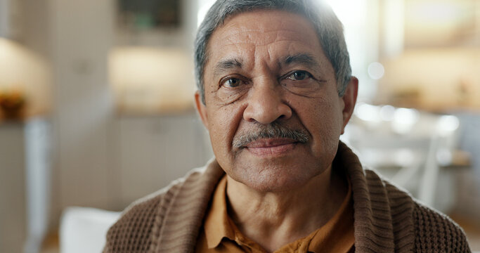 Happy, face and senior man in retirement, home and relax in living room with peace, freedom and wellness. Elderly, portrait and person with happiness or smile in nursing home, living room or house