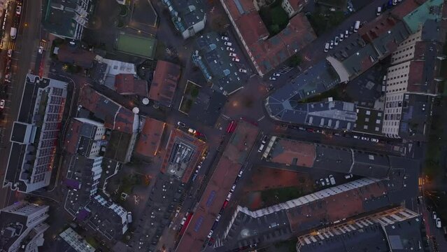 Top down panning shot of town development in city at dusk. Fly above residential urban borough. Geneva, Switzerland