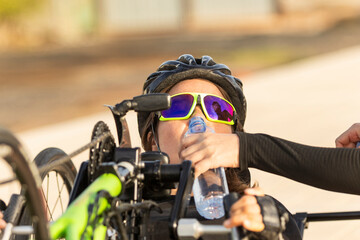 Determined adaptive athlete hydrating during training